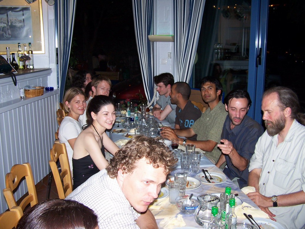 Photo of the author and others at table in Athens